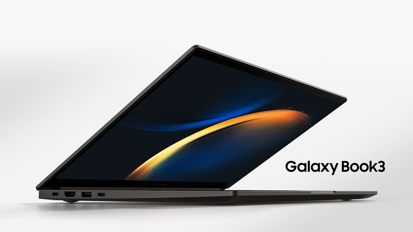 A graphite Galaxy Book3 is opened, facing slightly right with a black wallpaper onscreen.