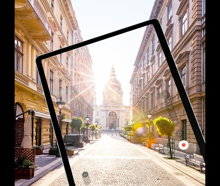 Galaxy Tab S9 FE+ displaying at full screen rays of sunlight over a city street captured by its camera with reduced glare to show a clearer image thanks to Vision Booster.