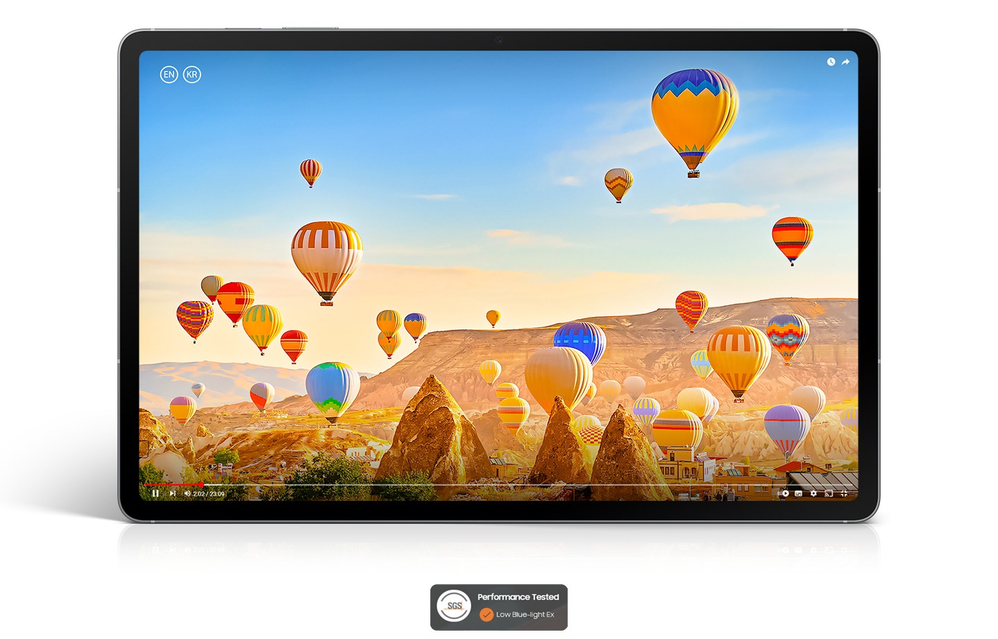 A video of colorful hot air balloons flying over a desert landscape is playing on the screen of Galaxy Tab S10 FE+ showcasing the bright, vibrant picture on the display. SGS Performance Tested Low Blue-light Ex logo shown.