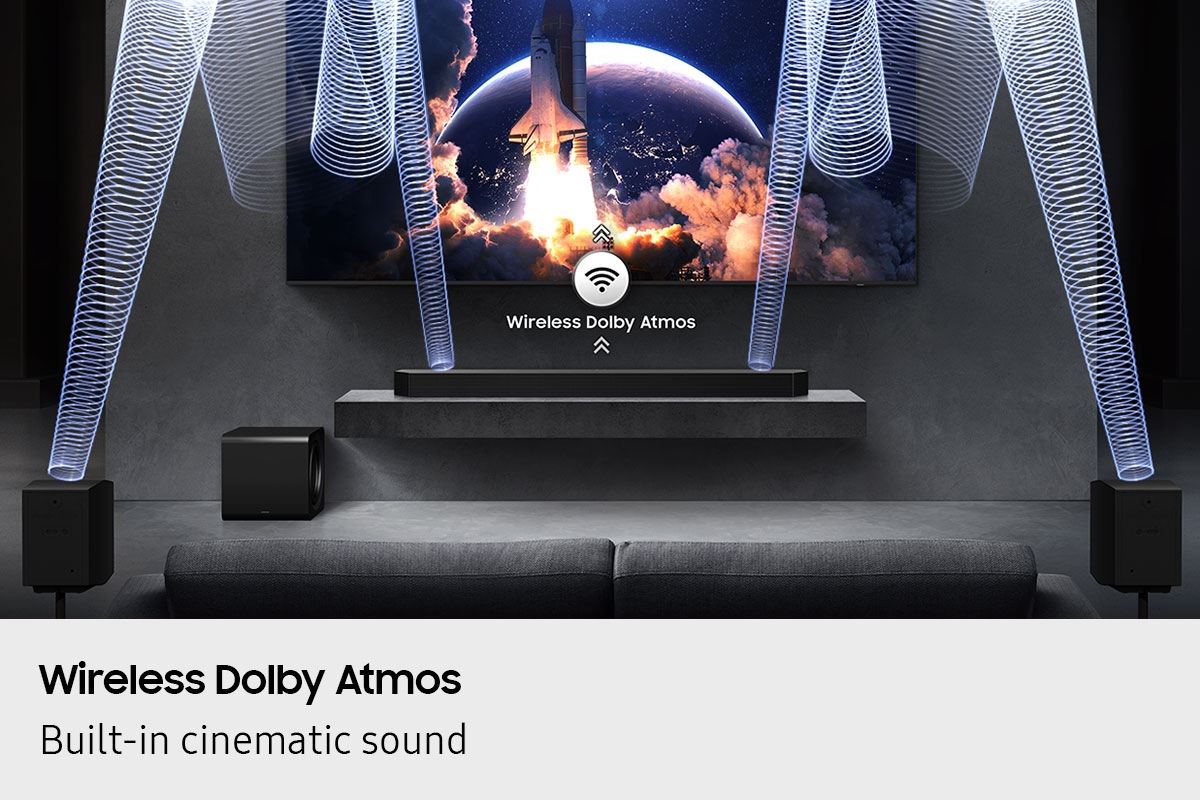 Wireless Dolby Atmos plays from Q990F below TV and rear speakers with sound waves and wireless icon with arrows pointing up.