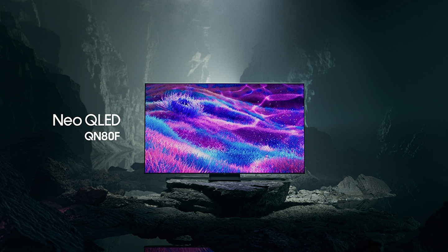 Samsung Neo QLED QN80F TV in a black and white underground space displays a colorful scene of an otherworldly landscape.