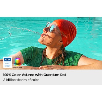 A woman is spitting out water in the pool. All the colors in the image become vivid as the brightness level increases. VDE tested logo is on display.