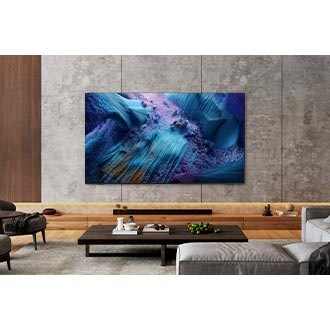 A Neo QLED TV is installed on the wall of a modern living room. The screen displays a blue abstract landscape.