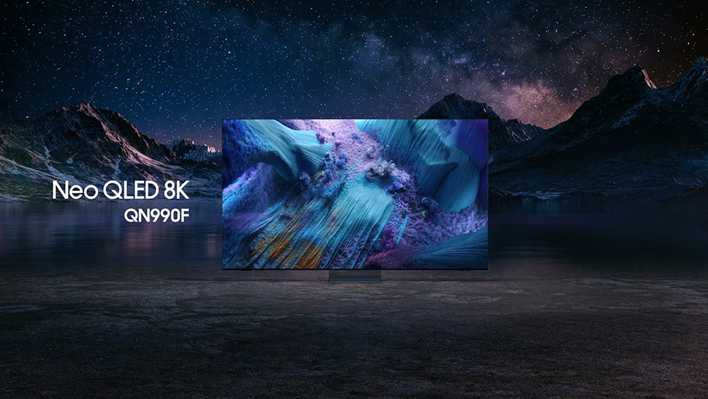 Samsung Neo QLED 8K QN990F TV against a mountain landscape at night displays a colorful scene of an otherworldly landscape.