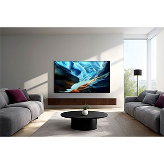 Modern living room surrounded by sofas and soft daylight, with wall-mounted Samsung OLED TV at the center showing vivid abstract art.