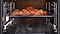 Shows a tray of croissants inside the oven being cooked using the convection system, while being surrounded by steam that is rising from a dedicated tray on the bottom of the oven.