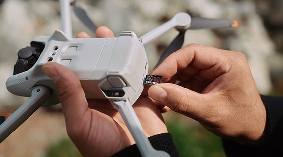 The hand that's putting a T9 in the drone