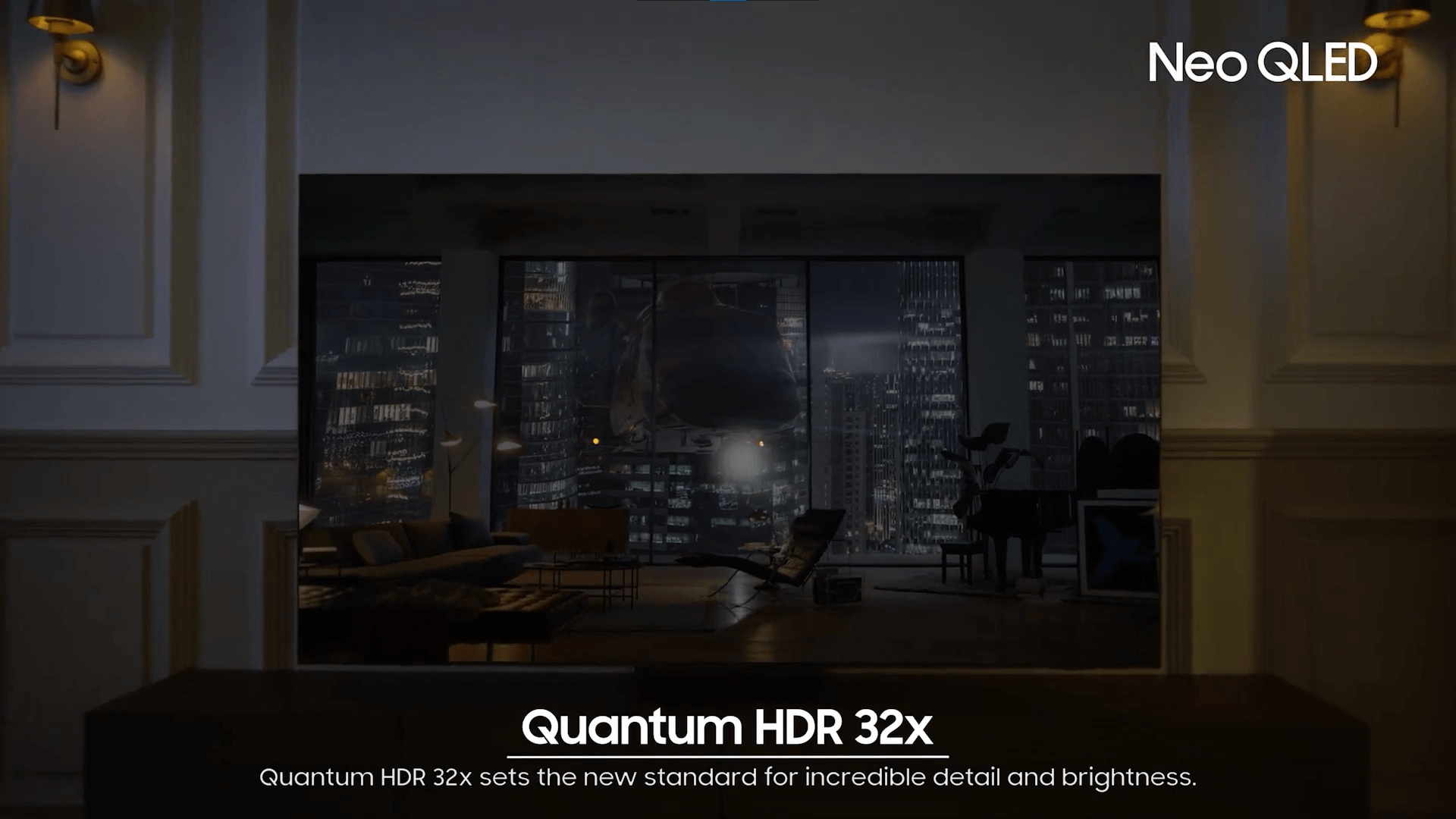 A Neo QLED TV is displaying a helicopter shooting light onto a building at night. Sound waves from its top channel speakers is filling the room.