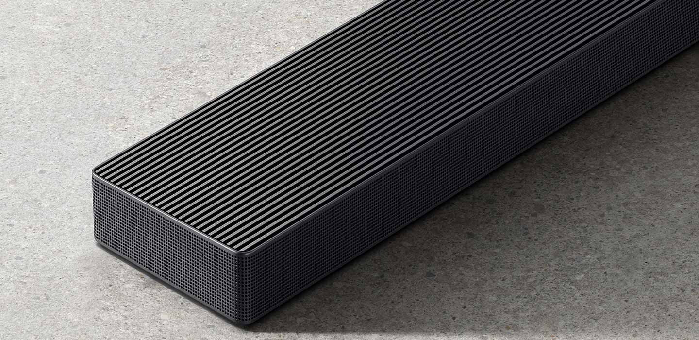 Close-up of QS700F soundbar's side panel. Roon Ready logo. TUV Rheinland Certified Product Carbon Footprint www.tuv.com ID 0217009957 logo. TUV Rheinland® Certified Product Carbon Reduction CO2↓ www.tuv.com ID 0217009945 logo.