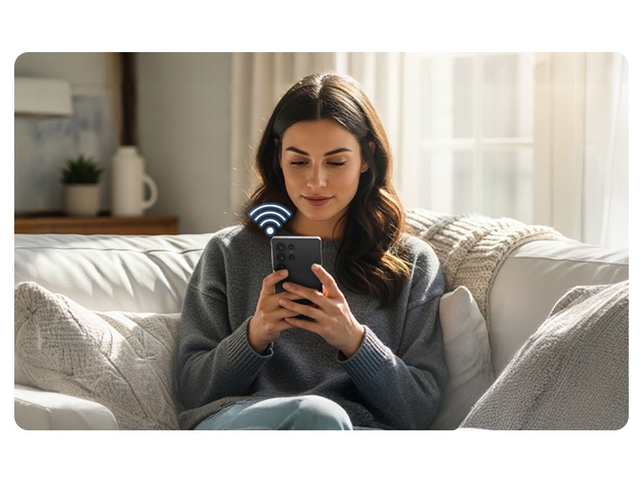 A person uses the SmartThings app on their smartphone while connected to Wi-Fi.