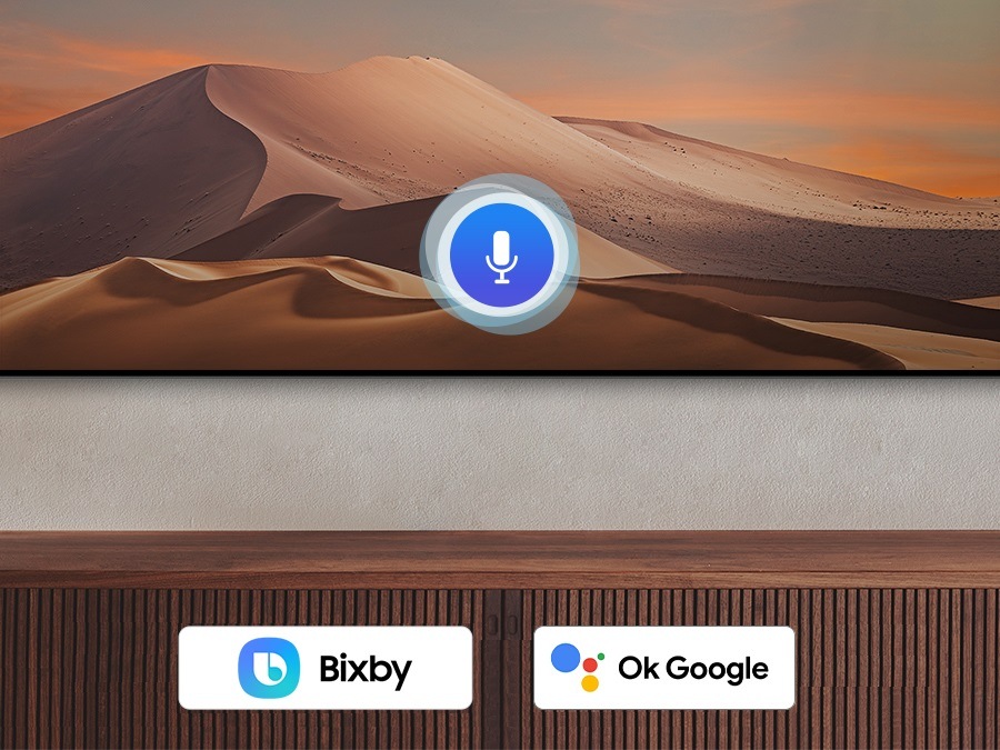 A microphone icon overlays an image, demonstrating voice assistant feature. The Bixby, Alexa built-in and the Hey Google logos are on display on the bottom.