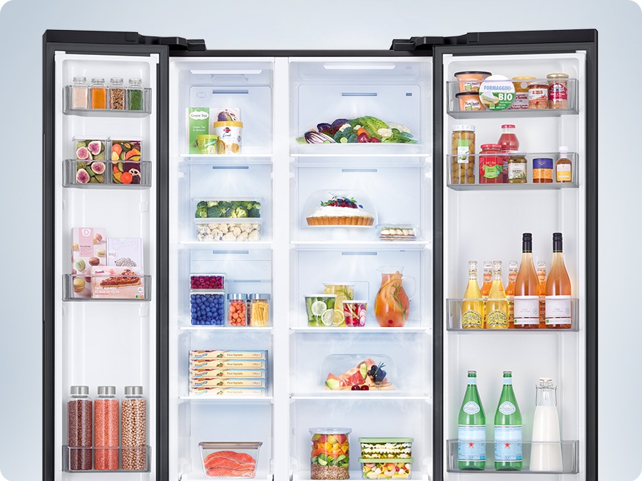 A refrigerator filled with various foods is open. Cool air comes out through vents in each compartment to maintain the optimum temperature for the food to stay fresh.