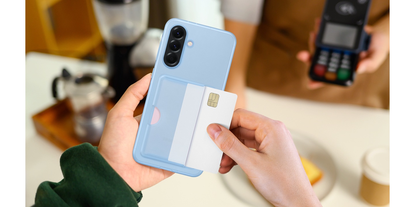 A close-up of a person holding Galaxy A56 5G in a Card Slot Case and taking the card out of the slot to make the payment in a coffee shop.