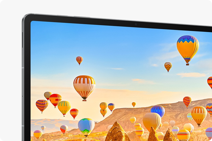 Colorful hot air balloons flying over a desert landscape is on the screen of Galaxy Tab S10 FE+ showcasing the bright, vibrant picture on the display.