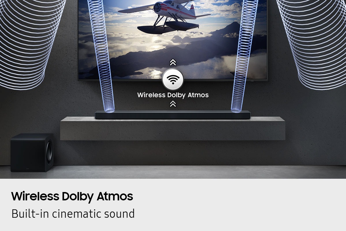 Wireless Dolby Atmos plays from QS700F soundbar below TV, as shown by sound waves and wireless icon with arrows pointing up.