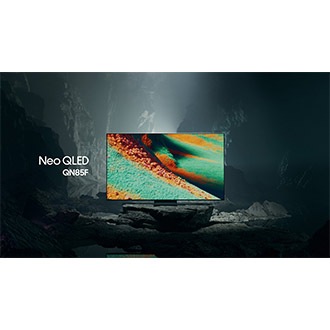 Samsung Neo QLED QN85F TV in a black and white underground space displays a colorful scene of an otherworldly landscape.