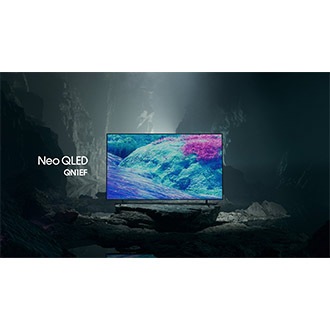 Samsung Neo QLED QN1EF TV in a black and white underground space displays a colorful scene of an otherworldly landscape.