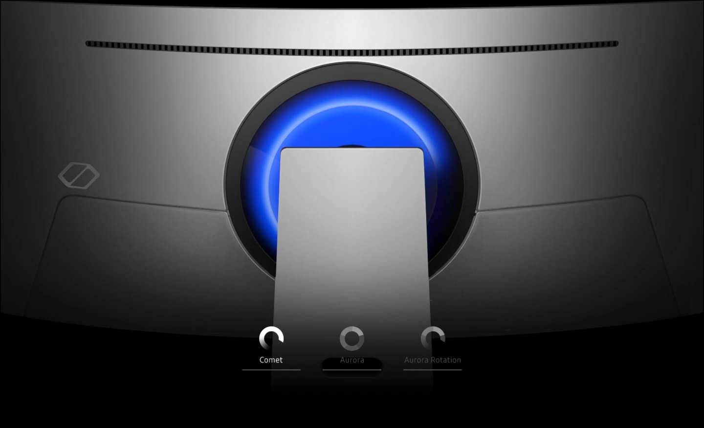 A closeup of the back of an Odyssey monitor is shown. Three icons float across the bottom, which read, “Comet, Aurora, and Aurora Rotation” from left to right. The connection point shows a blue ring around it while Comet is highlighted, followed by a rainbow ring while Aurora is highlighted.