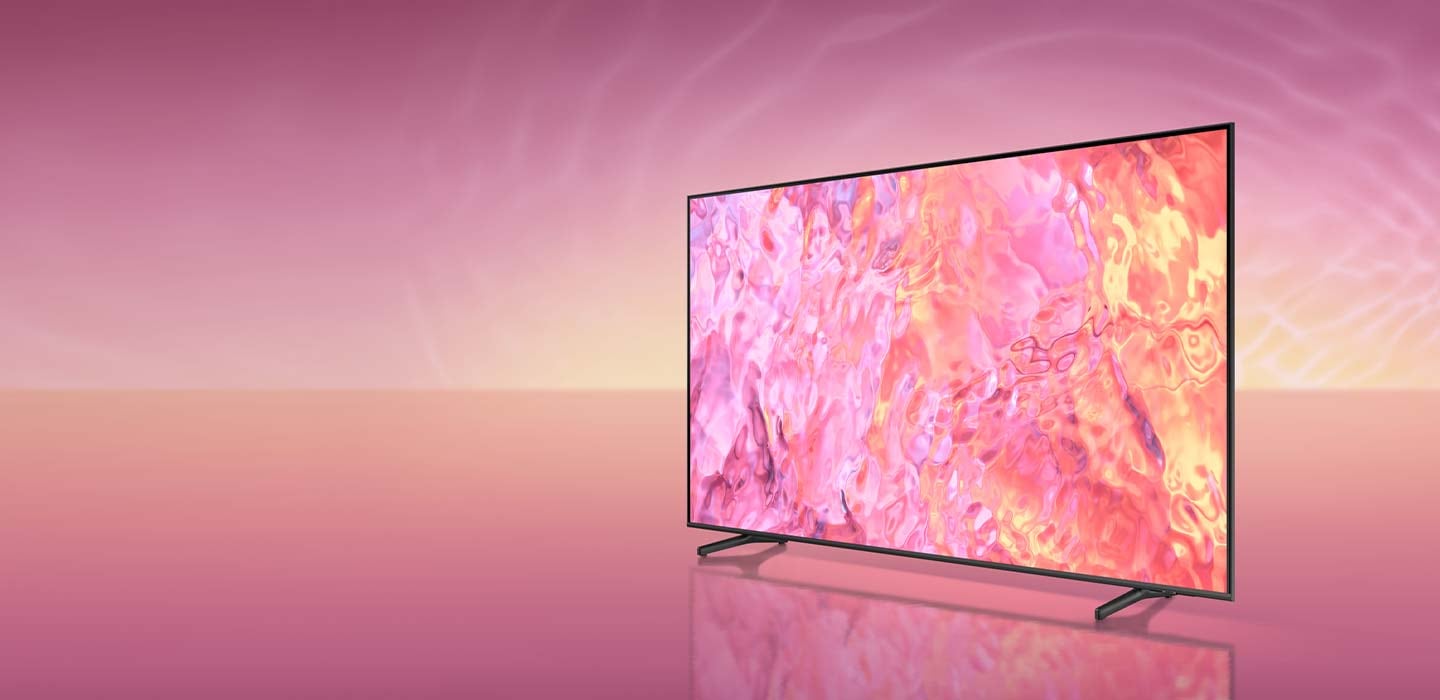A QLED TV with a branch stand is displaying pink graphic on its screen.