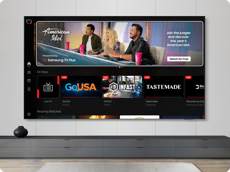 TV in a living room shows Samsung TV Plus home screen and the diverse TV channels available with it.