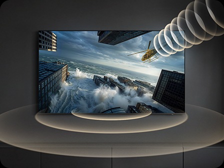 A Samsung TV displays a helicopter flying across the screen, while visual sound waves follow its movement, illustrating the Object Tracking Sound feature that directs audio to match on-screen motion.