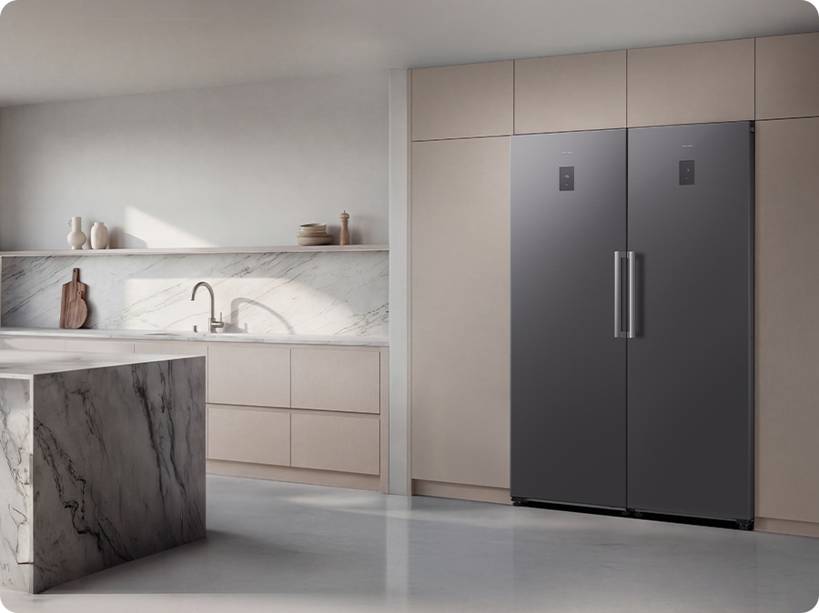 The fridge and freezer are installed in the modern kitchen. The sleek exterior of the refrigerator gives a clean look to the modern kitchen, with a flat finish.