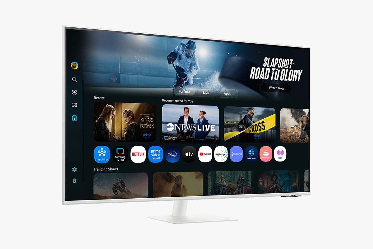 Front-left perspective of 43 inch Samsung Smart Monitor M7. Screen showing Smart TV Apps page with various content and apps lined up.