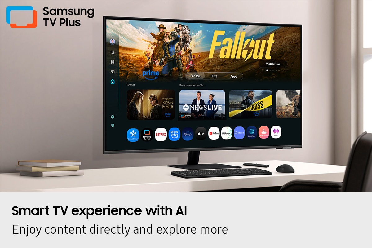 Smart TV experience with AI. Enjoy content directly and explore more. Monitor on desk displays Smart TV Apps page with various content and apps lined up. Samsung TV Plus logo.