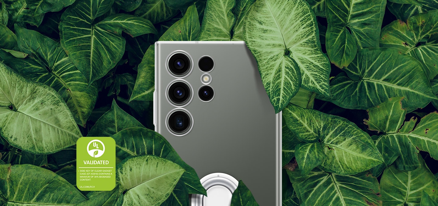 Back view of a Galaxy S23 Ultra device wearing a Clear Gadget Case is shown surrounded by thick green leaves. The text reads SIDE KEY OF CLEAR GADGET CASE (EF-XS918) CONTAINS A MINIMUM OF 34% BIOBASED CONTENT.