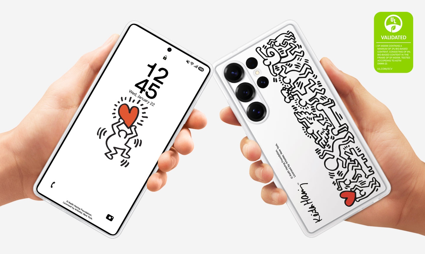 Two hands each hold a Galaxy S25 Ultra, both installed with the Flipsuit Case. One shows the smartphone from the screen side and the other shows it from the back, where the case's Keith Haring graphic is shown. On the upper right corner is a UL Environmental Claim Validation Mark that reads 'EF-MS938 CONTAINS A MINIMUM OF 2% BIO-BASED CONTENT, CONSISTING OF 8% BIO-BASED CONTENT IN THE FRAME OF EF-MS938, TESTED ACCORDING TO ASTM D6866-22. UL.COM/ECV'.