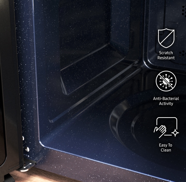 Shows the smooth CERAMIC INSIDE™ surface inside the microwave oven. The icons and text highlight that it has †Anti-bacterial activity' and is †Easy to clean'.