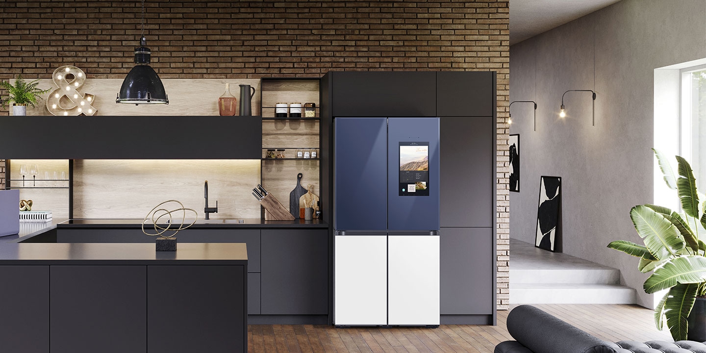 Placed in a stylish kitchen, the Samsung 934L French Door Smart Refrigerator has a two-tone finish that blends seamlessly with the tones of the room.