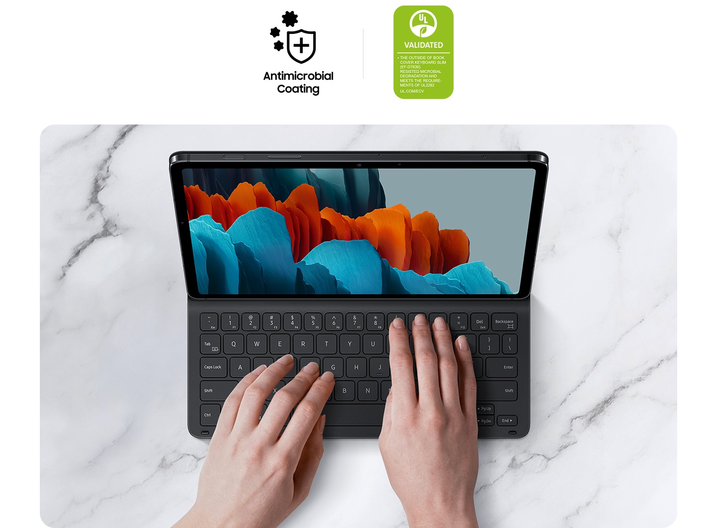 Two hands seen using Galaxy Tab S7 inside Book Cover keyboard Slim. Two logos state Antimicrobial Coating and VALIDATED. Text says The outer surface of Book Cover Keyboard Slim (EF-DT630) resisted microbial degradation as tested by JIS Z 2801 and meets the requirements of UL 2282 UL.COM/ECV.