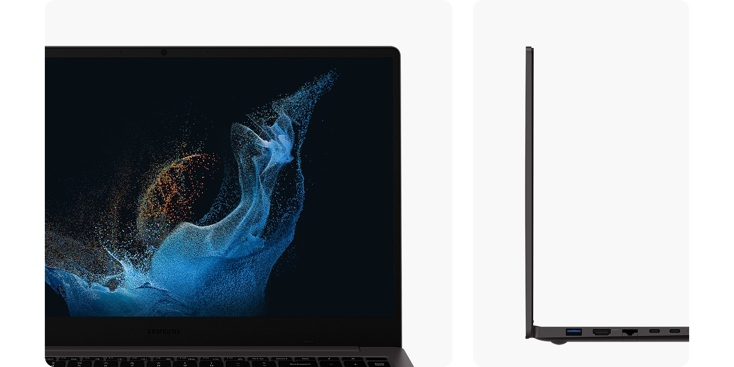 Two graphite-colored Galaxy Book2 devices are next to each other. The one on the left is fully open towards the front and there is a blue and brown wavy wallpaper on the screen. The one on the right is the side view of the pc.