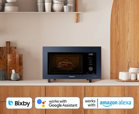 shows the microwave with samsung bixby, amazon alexa and google assistant logos, as it can be controlled by voice or app.