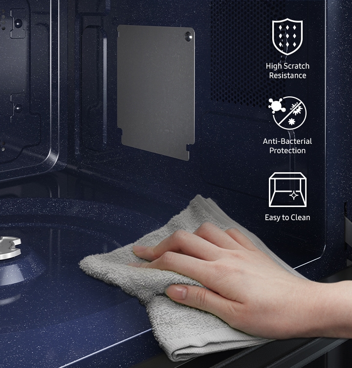 Shows a person wiping clean the smooth and durable CERAMIC INSIDE™ surface of the microwave oven's cavity. Icons show that the surface has &quot"High scratch resistance&quot", provides &quot"Anti-bacterial protection&quot" and is &quot"Easy to clean&quot".