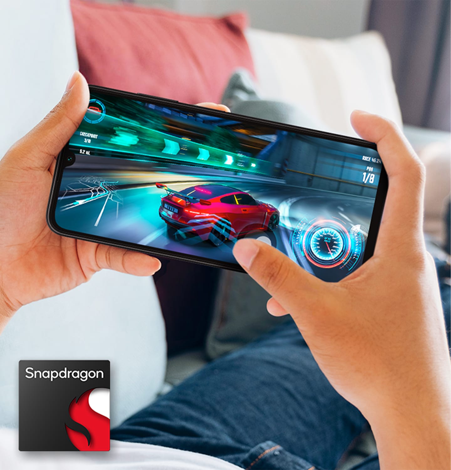 Two hands holding a Galaxy A05s shows racing gameplay on-screen. At the bottom left corner, the Snapdragon logo is shown.