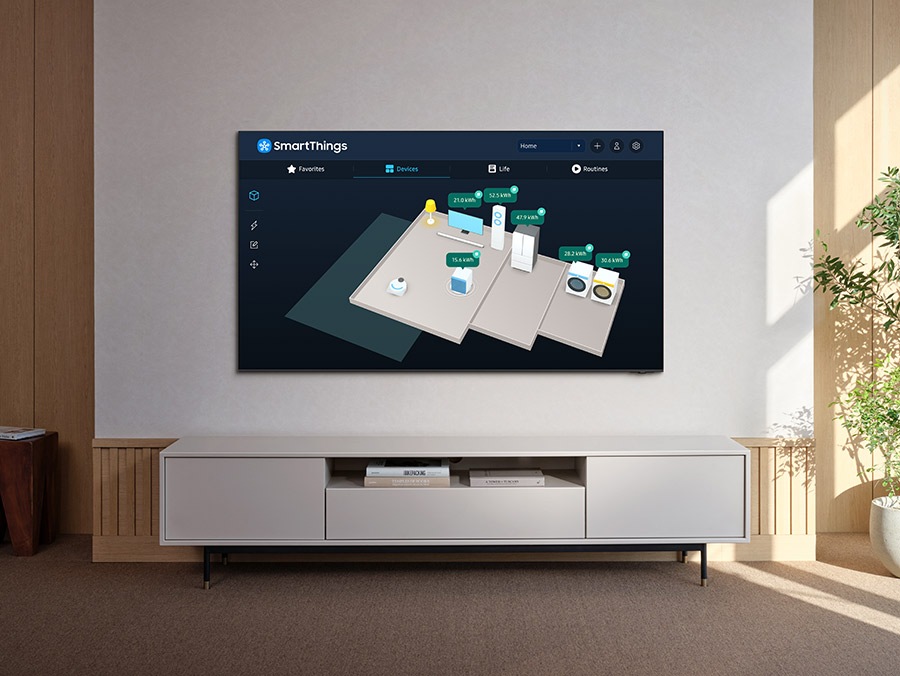 SmartThings on Samsung TV shows a 3D Map View of a home with various connected devices. It shows the light is on, TV is on SmartThings Mode, refrigerator has its door closed and air purifier is on Auto mode. The energy levels can also be seen for each device on the screen.