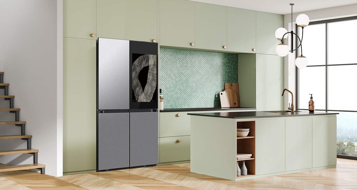 There is a french door Bespoke refrigerator in a sunlit contemporary kitchen with green cabinetry and a kitchen island.