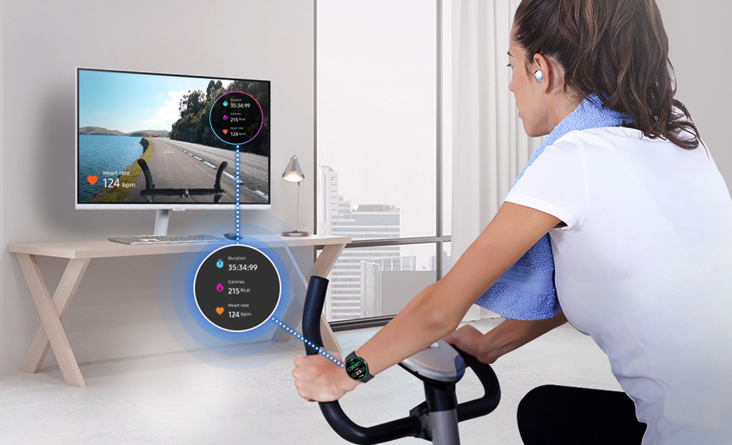 A woman is riding an indoor bicycle. She is wearing a Galaxy Watch and Buds, and her watch screen is overlaid on the monitor.