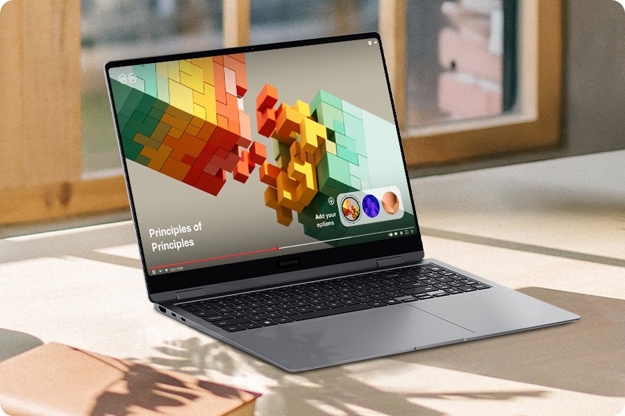 Galaxy Book5 Pro 360 is placed on a brightly lit desk, open and facing slightly right with a video playing in full screen. The onscreen image is clear and vibrant with improved visibility thanks to Vision Booster.
