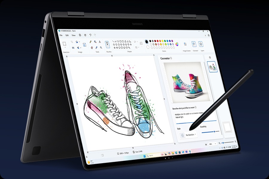 Galaxy Book5 Pro 360 folded like a tent with the screen facing right and Paint app open in full screen with the Cocreator feature being used to turn a sketch of a pair of sneakers into an AI-generated design image. S Pen is touching the screen.