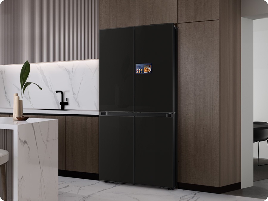 There is a Bespoke AI home refrigerator with Clean Deep Charcoal panel in a stylish kitchen.