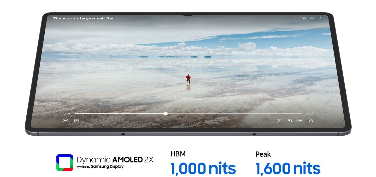 A Galaxy Tab S11 Ultra device playing a video of a person in a vast, bright landscape on its large display, showcasing ultra-clear visibility. Text below reads Dynamic AMOLED 2X vivified by Samsung Display, HBM 1000 nits, Peak 1600 nits.
