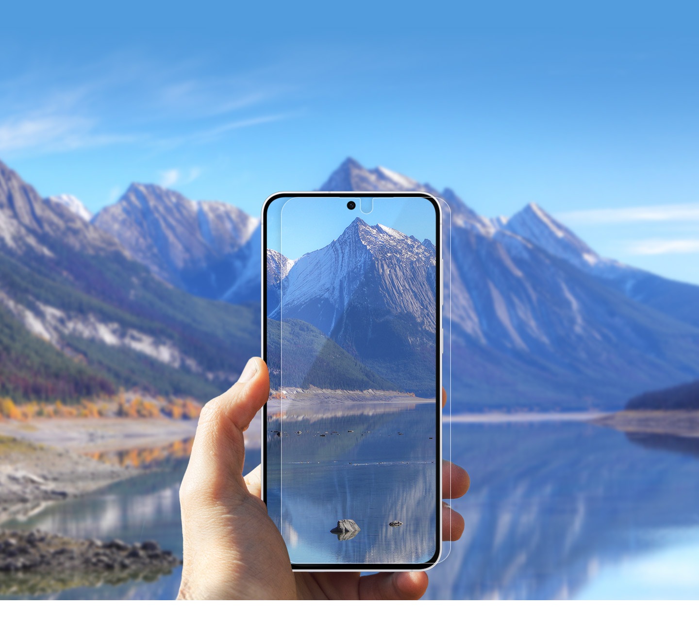 A left hand is holding out a Galaxy S25 FE applied with the Anti-reflecting Film towards a beautiful scenery of mountains and a lake. The phone display shows this scenery.