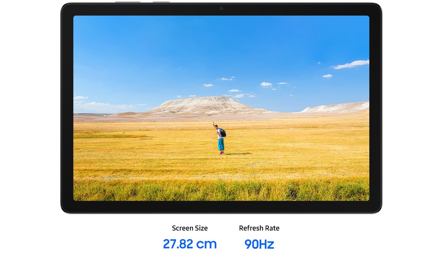Galaxy Tab A11+ is placed horizontally, displaying a clear image of a man waving his hands, suggesting a free-spirited mood. In the background, a blue sky stretches over a wide horizon of yellow and brown grass. Text reads Screen Size 11.0-inch, Refresh Rate 90 Hz.