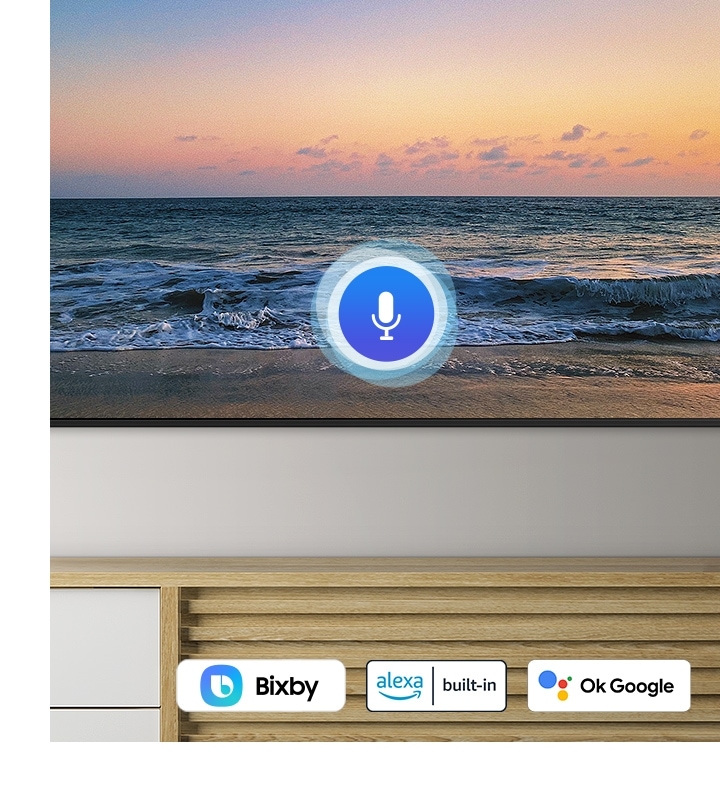 A microphone icon overlays a beach sunset TV screen image, demonstrating UHD TV voice assistant feature.