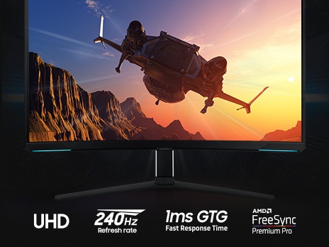 On the monitor display which is front facing, an aircraft is flying toward the sun over a mountain landscape. Underneath the stand of the monitor are four logos, demonstrating UHD resolution, 240Hz refresh rate, 1ms GTG response time and NVIDIA G-SYNC compatibility.