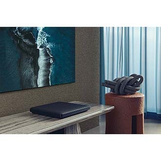 Samsung QLED QN800A is hanging on the living room and Attachable slim one connect is placed under the TV.