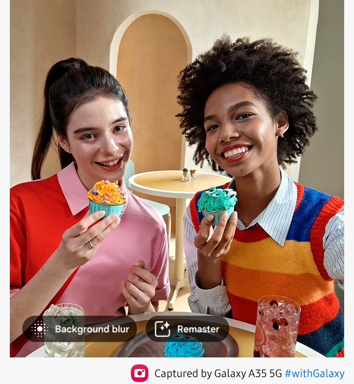 Two people smiling and holding cupcakes. with options for Background blur, Remaster. Text reads Captured by Galaxy A35 5G #withGalaxy.